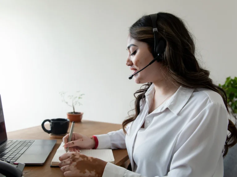 Customer support representative wearing a headset for Web development outsourcing