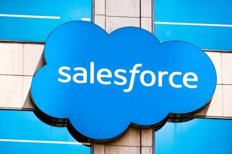 Salesforce blue cloud logo on a glass building.