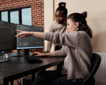 Development team reviewing software implementation on a workstation
